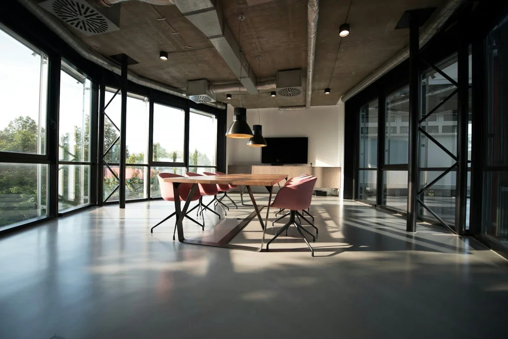 Ambiente real de escritório com mesas de trabalho e iluminação natural